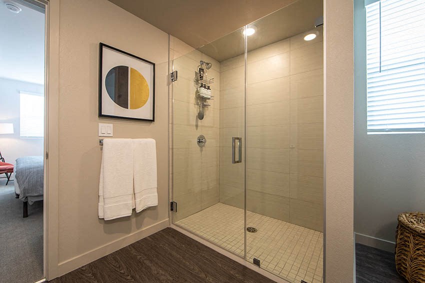 a bathroom with a glass shower and a white towel