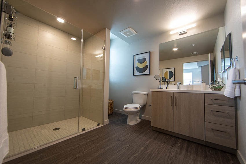 a bathroom with a shower toilet and sink