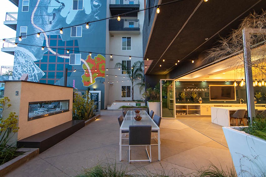 a dining area with a table and chairs outside of a building