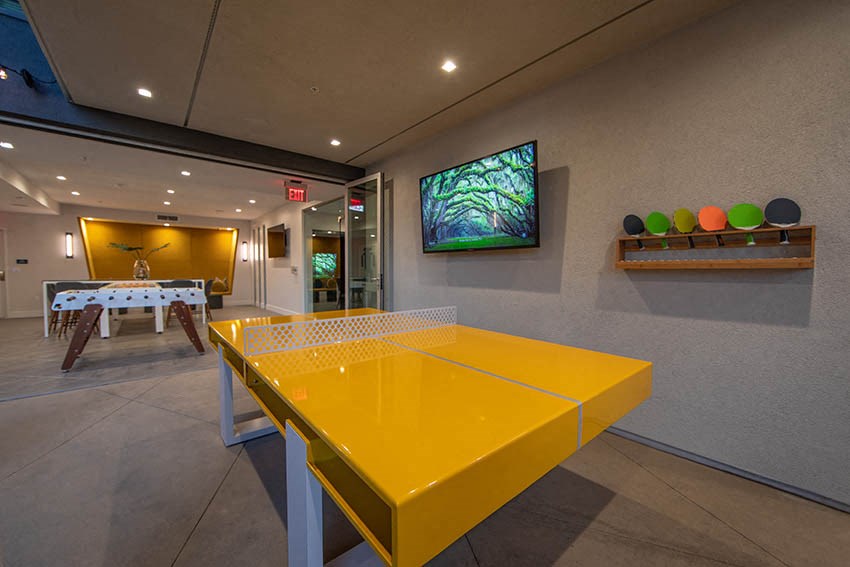 a ping pong table in the game room of a house