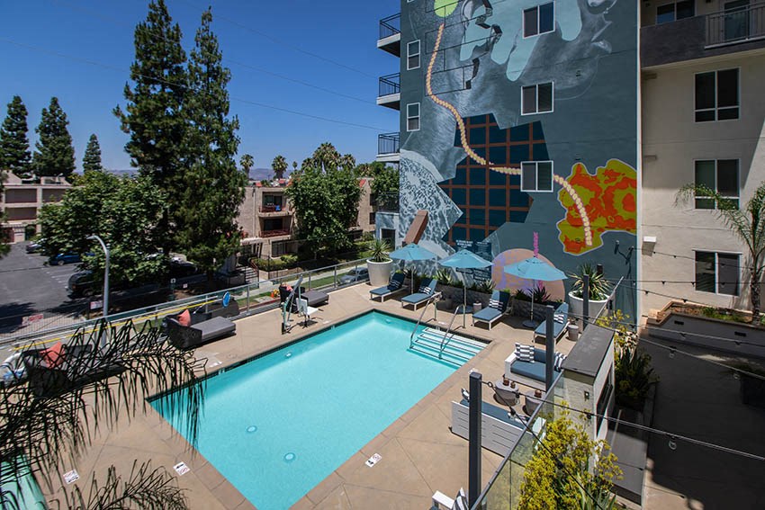 a pool and a building with a mural
