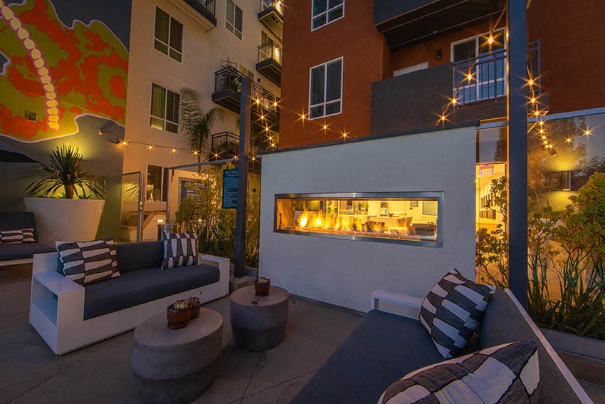 a living room with couches and a fire pit