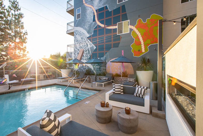 a swimming pool with a mural on the side of a building