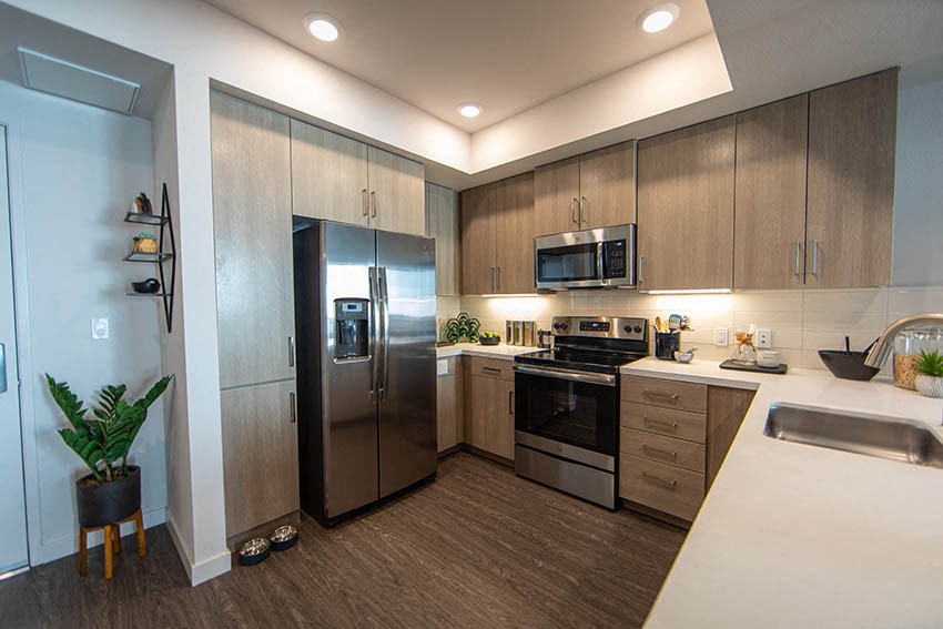 a kitchen with stainless steel appliances and a refrigerator
