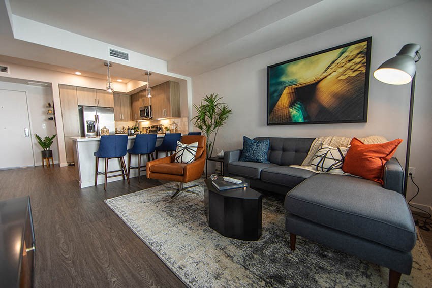 a living room and kitchen with a couch and a table