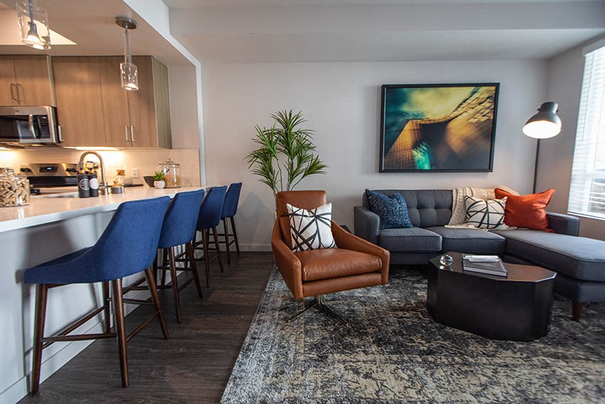 a living room with a kitchen and a couch