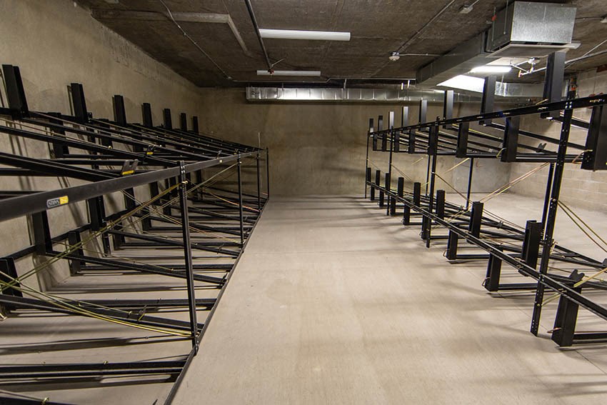 a row of empty tables in a storage room