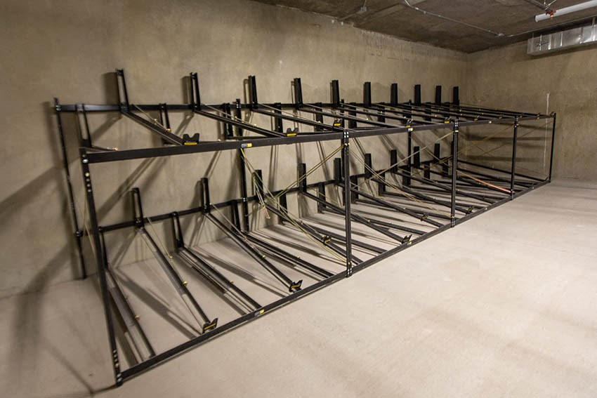 a bunch of empty beds in a concrete room