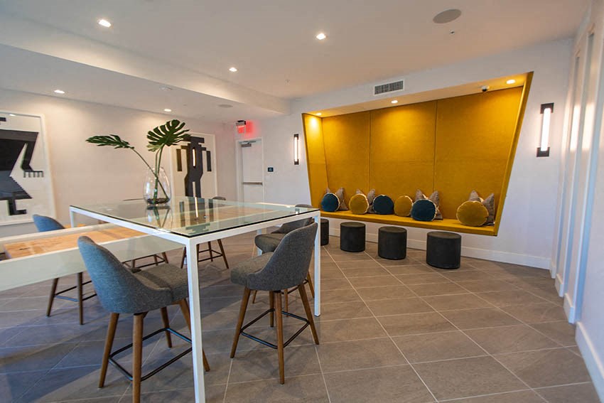 a dining room with a glass table and chairs