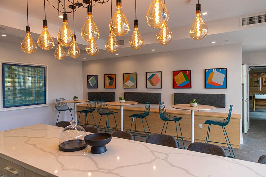 a kitchen with a table and chairs and lights