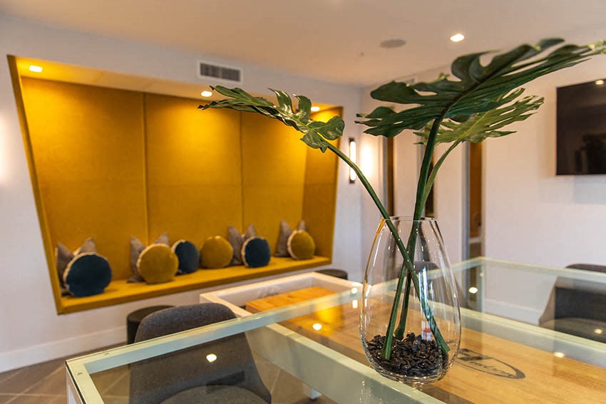 a glass table with a vase with flowers on it