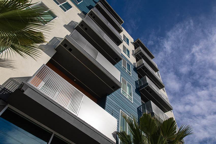 a tall building with some palm trees in front of it
