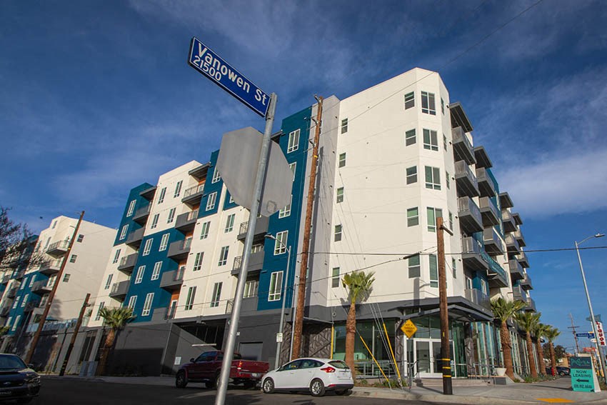 a street sign in front of a tall building
