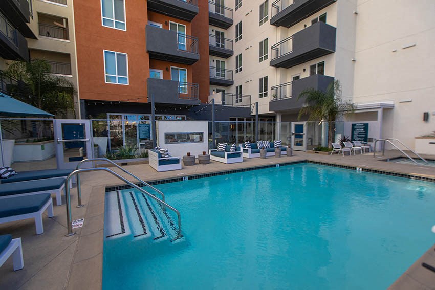 a swimming pool in front of an apartment building