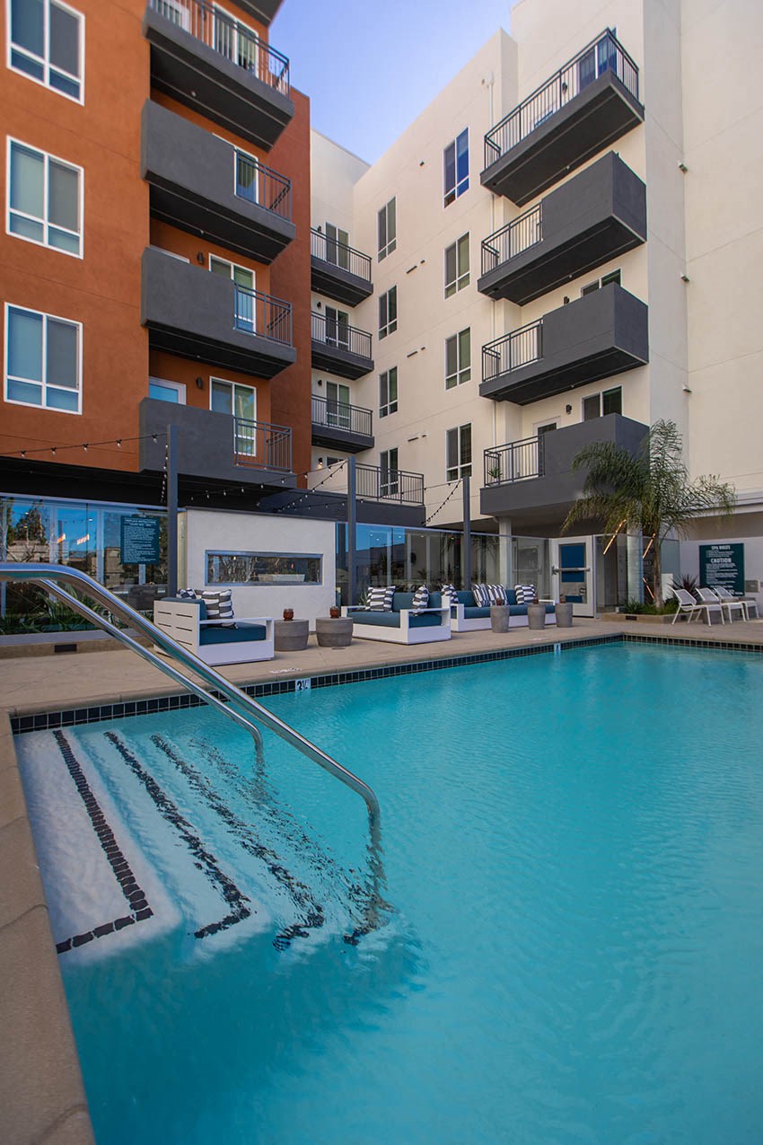 a swimming pool in front of an apartment building