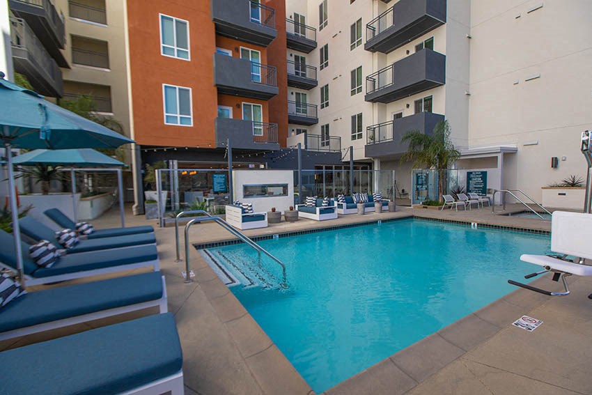 a swimming pool in front of an apartment building