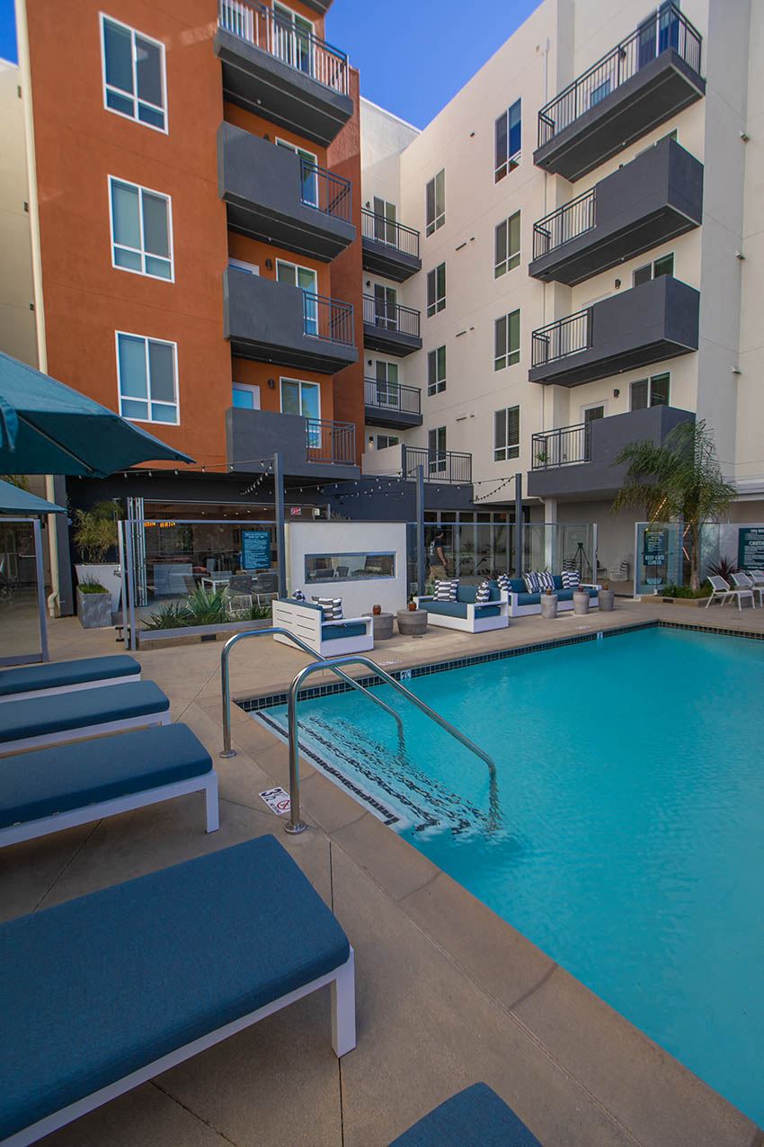 a swimming pool in front of an apartment building