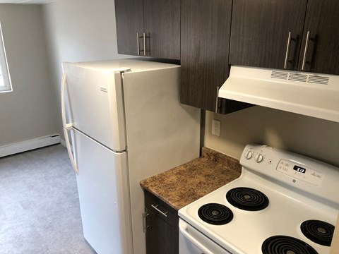 a kitchen with a stove and a refrigerator