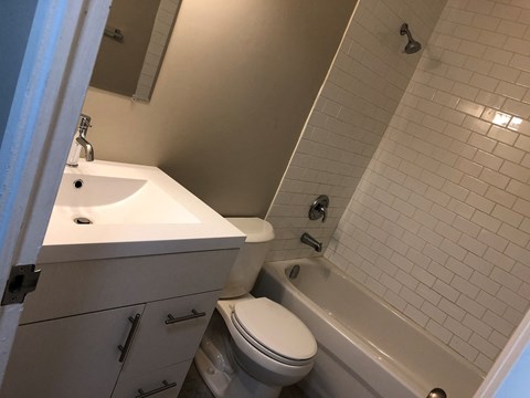 a bathroom with a sink and a toilet and a tub