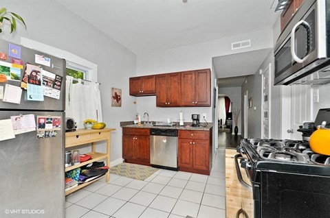 a kitchen with stainless steel appliances and wooden cabinets