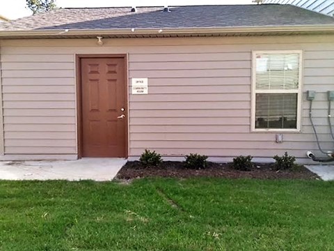 a front door of a house with a yard and grass