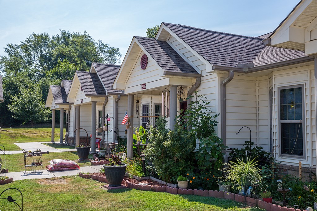 a row of houses with a yard and grass