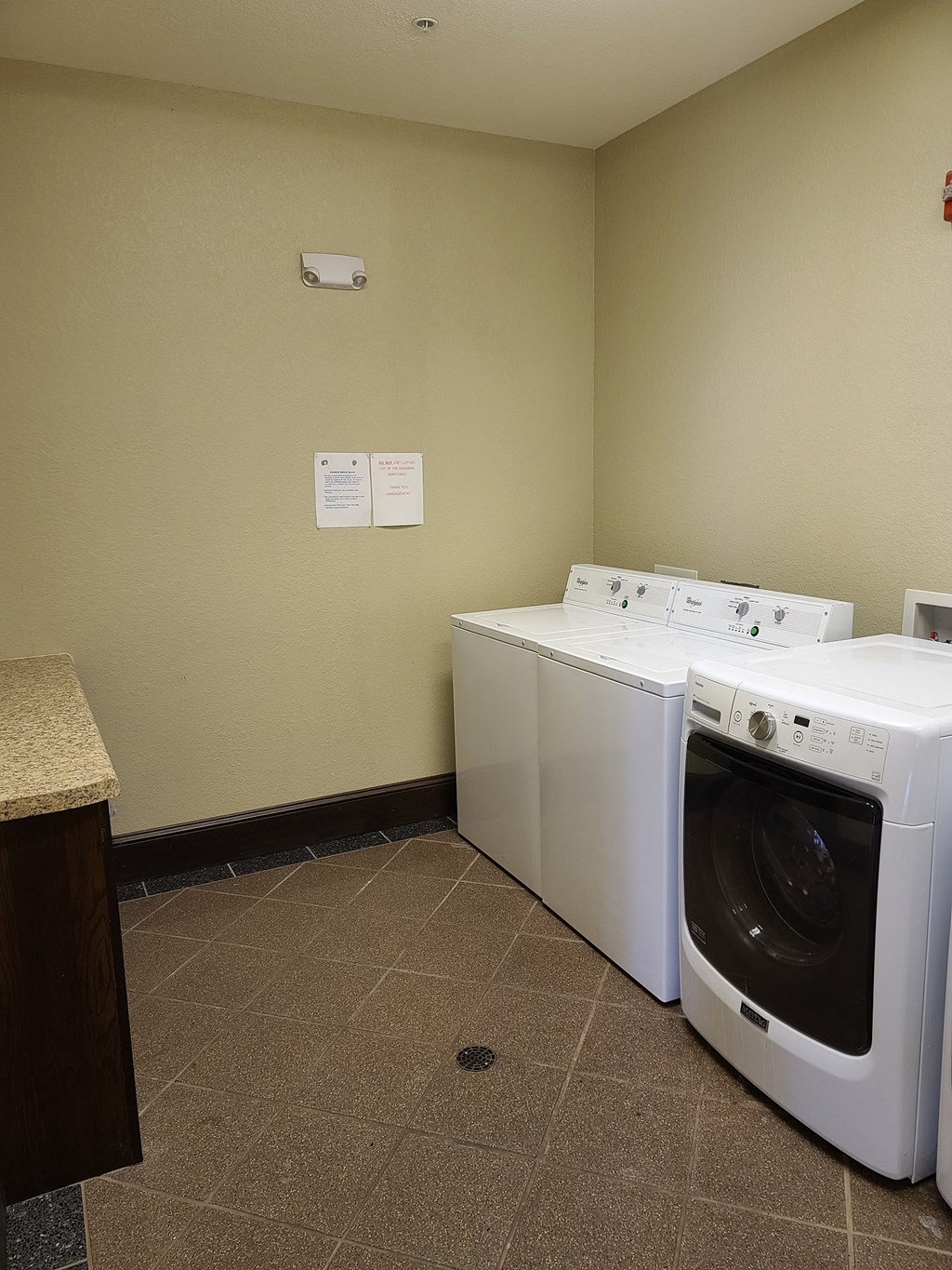a laundry room with two washers and two washing machines