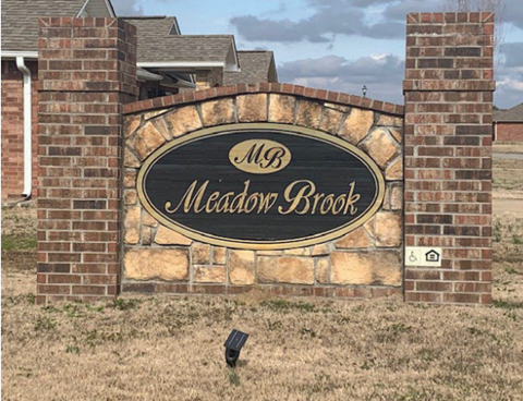 a brick wall with a sign for the masonry brook sign