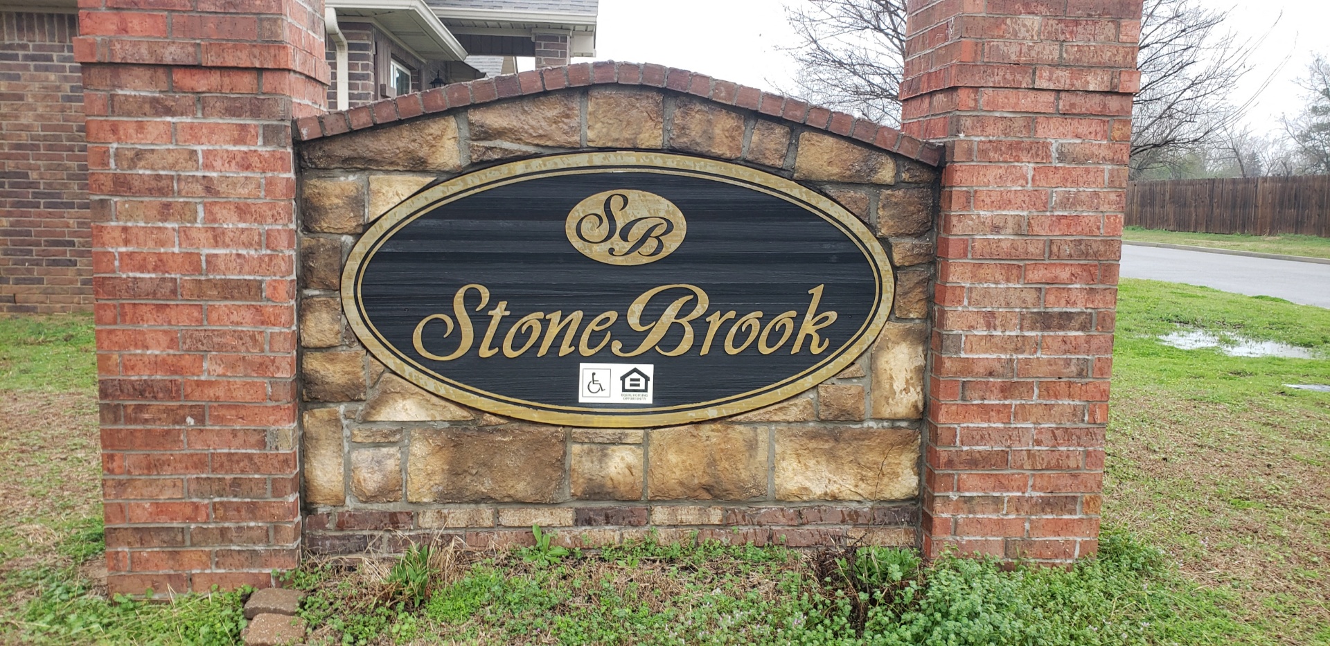 a stone brick sign in front of a building