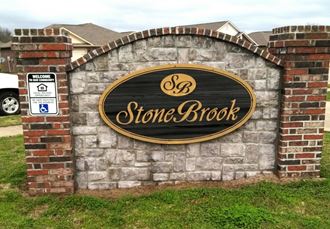 a stone brick wall with a sign for stone brook