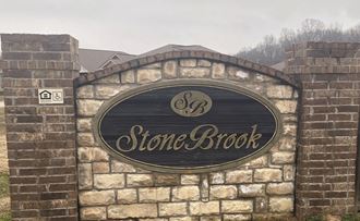 a stone brick building with a sign on it
