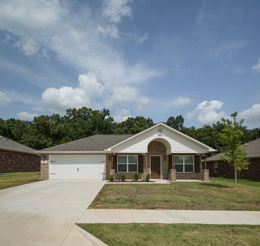 a house with a driveway and a lawn