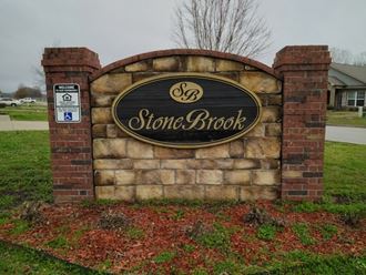 a stone brick sign with the stone brook logo on it