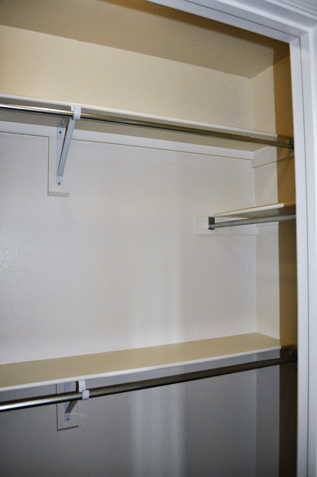 an empty closet with a sliding glass door
