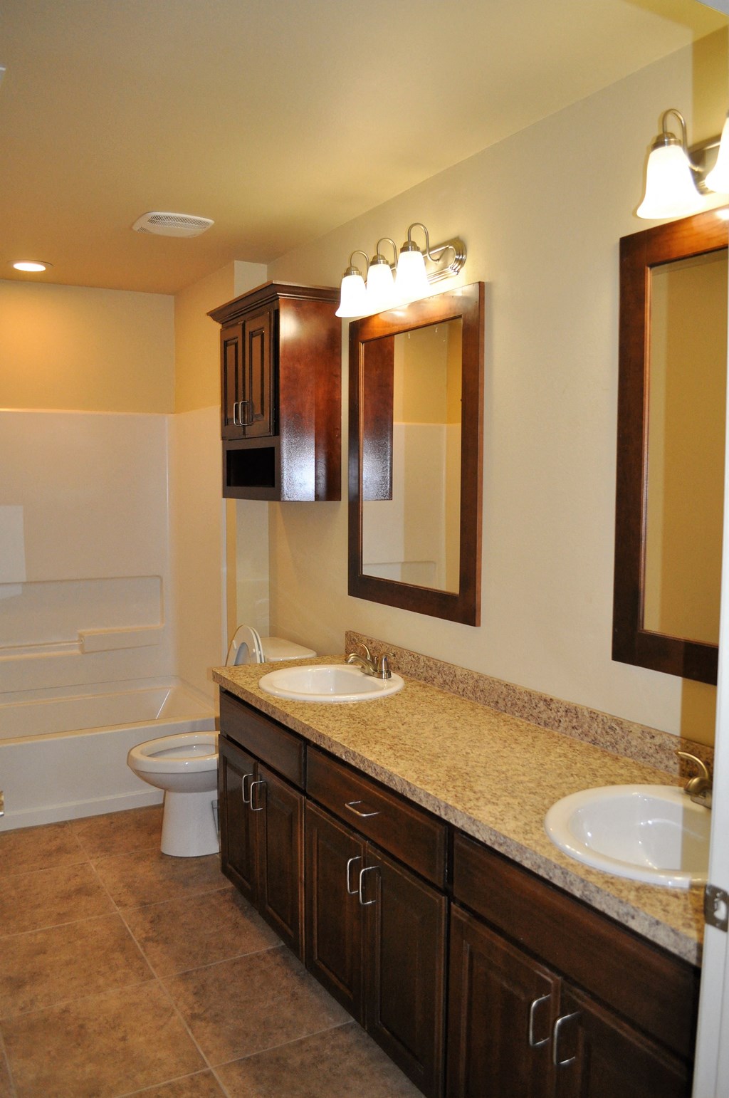 a bathroom with two sinks and a toilet