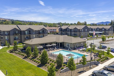 an aerial view of an apartment complex with a swimming pool
