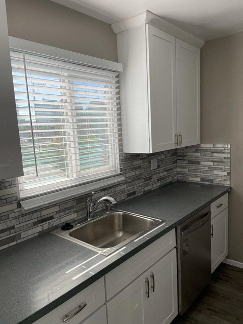 a kitchen with a sink and a window