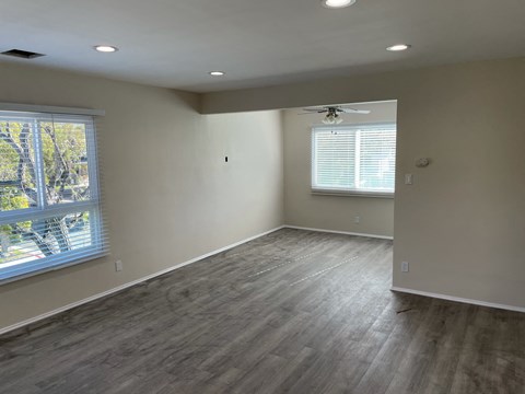 a living room with wood floors and a window