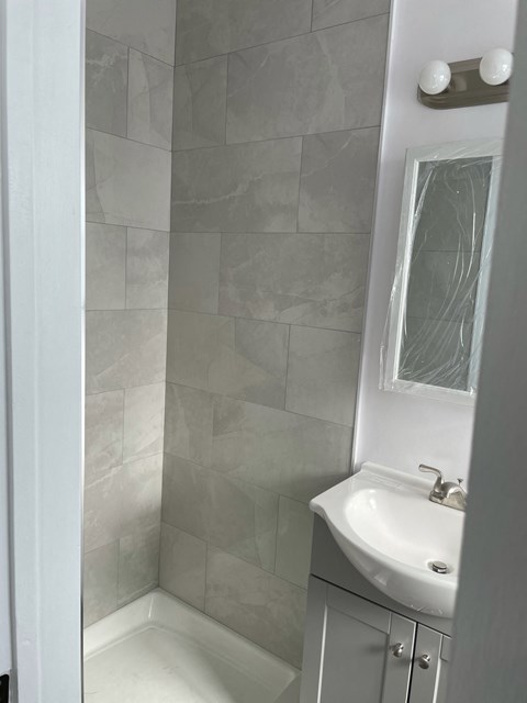 a small bathroom with a sink and a shower