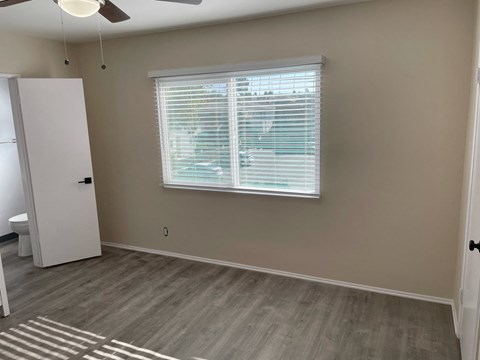 a living room with a window and wood floors
