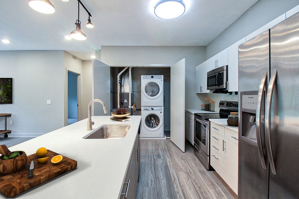 a kitchen with stainless steel appliances and a washing machine