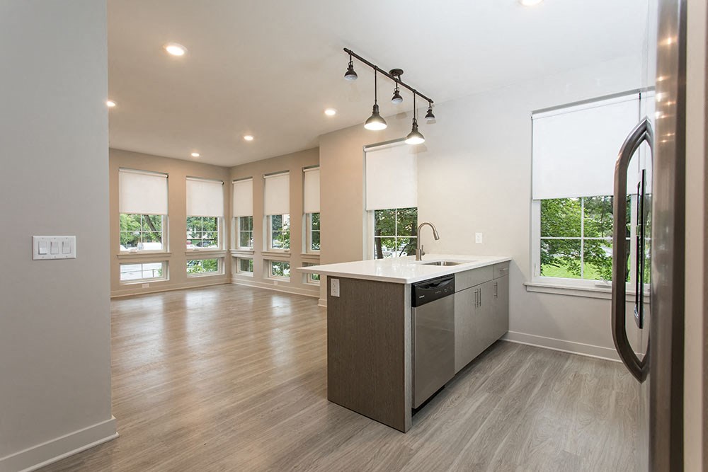 an empty kitchen and living room with a large window