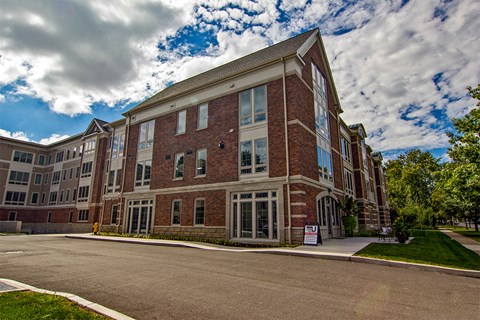 a large brick building with a cloudy sky in the background