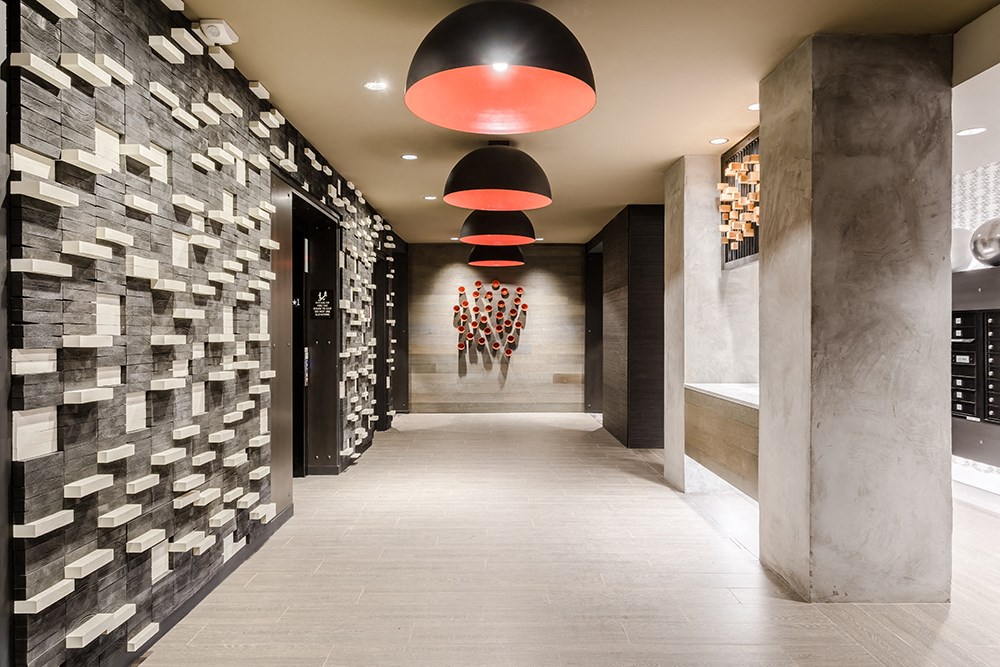 a long hallway with stone walls and red lamps and a long walkway