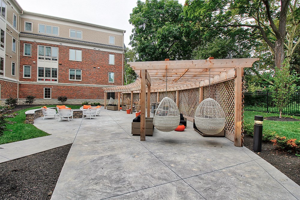 a courtyard with a hammock swing and a pergola