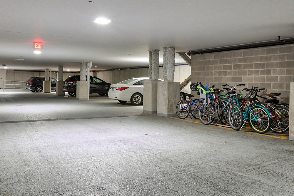 a row of bikes parked in a parking garage