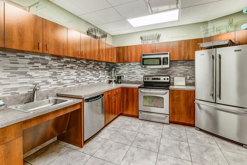 a kitchen with stainless steel appliances and wooden cabinets