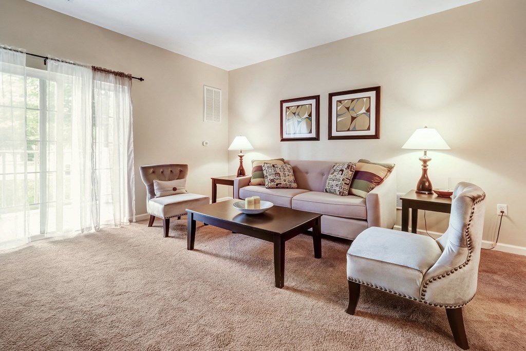 a living room with a couch and chairs
