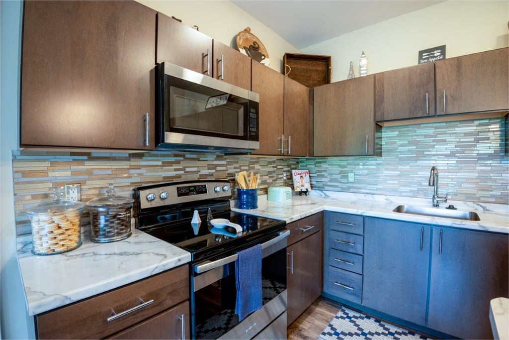 a kitchen with stainless steel appliances and wooden cabinets