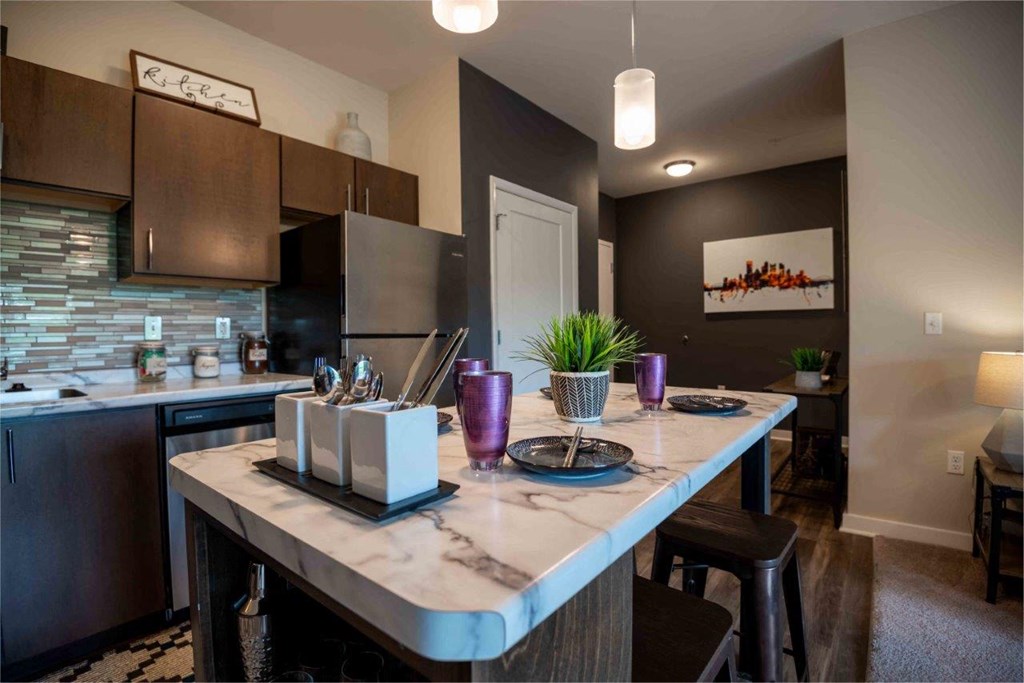 a kitchen with a long island with a counter top